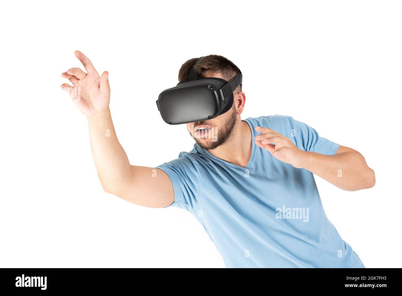 Young man playing with a VR glasses on a white background Stock Photo