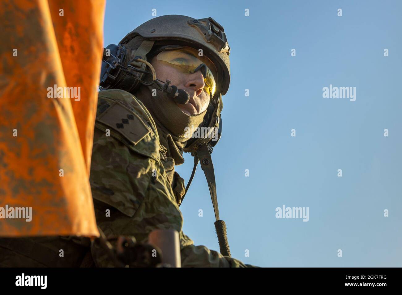 Australian Army Soldier Capt. Benjamin Peterson, tank officer instructor at the school of armour, observes the convoy of armoured vehicles before starting the movements for rehearsal of live fore ranges during Exercise Koolendong at Bradshaw Field Training Area, NT, Australia, Aug 25, 2021. Peterson was the safety officer for the mounted and dismounted attacks by the armoured vehicles during the exercise. Exercises like Koolendong validate MRF-D’s and the ADF’s ability to conduct expeditionary advanced base operations with combined innovative capabilities; and through their shared commitment, Stock Photo