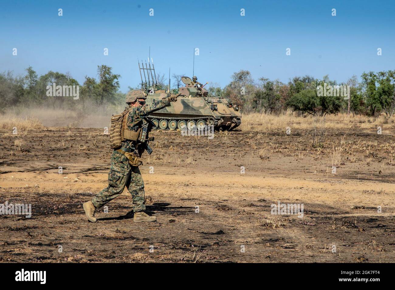 U.S. Marine Corps 1st Lt. Michael Rivera, a platoon commander with Company B., 1st Battalion, 7th Marine Regiment (Reinforced), Marine Rotational Force – Darwin, directs an Australian M113 AS4 Armored Personnel Carrier during a dry-run rehearsal at Bradshaw Field Training Area, NT, Australia, Aug. 25, 2021. The dry-run rehearsals were in preparation for a live-fire event between Marines and the Australian Army for Exercise Koolendong. Exercise Koolendong validates MRF-D’s and the Australian Defence Force’s ability to conduct expeditionary command and control operations, demonstrating the share Stock Photo