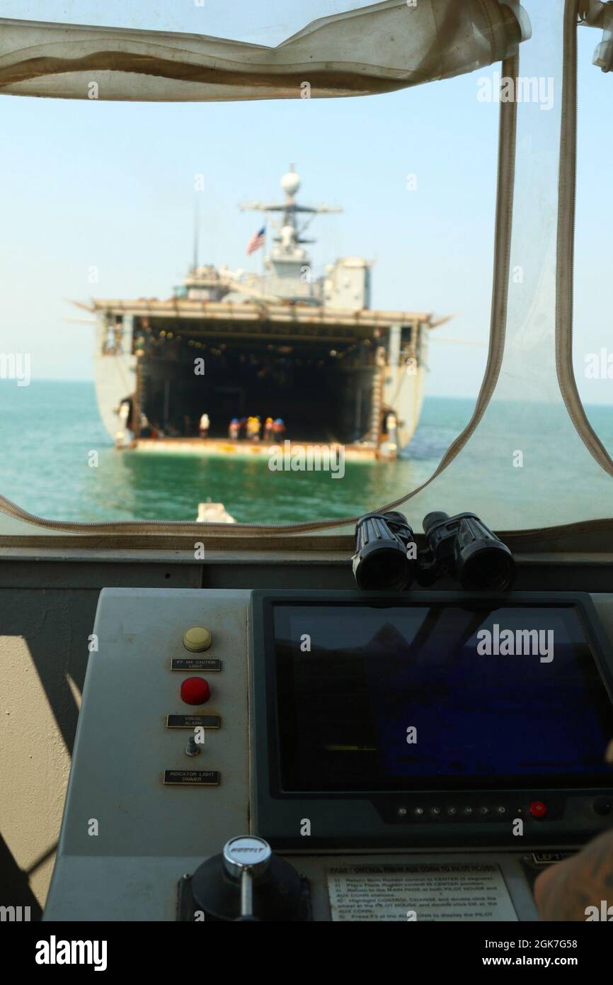 A U.S. Navy landing craft mechanized and utility (LCM/ LCU) sails to a USS Oak Hill (LSD51) to