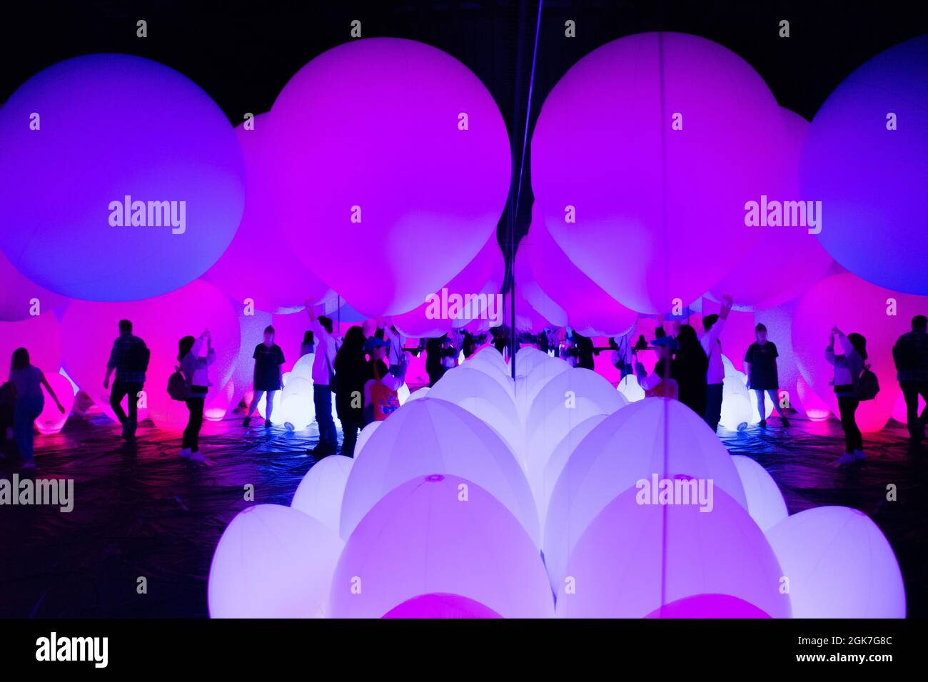 People silhouetted by the extraordinary light displays at the Team Lab Borderless Digital Art Museum, Tokyo, Japan, October Stock Photo