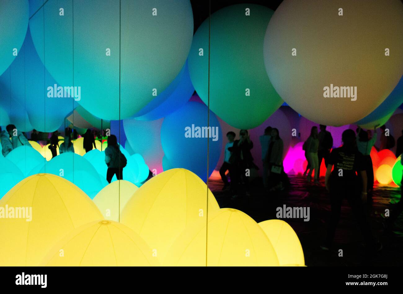 People silhouetted by the extraordinary light displays at the Team Lab Borderless Digital Art Museum, Tokyo, Japan, October Stock Photo