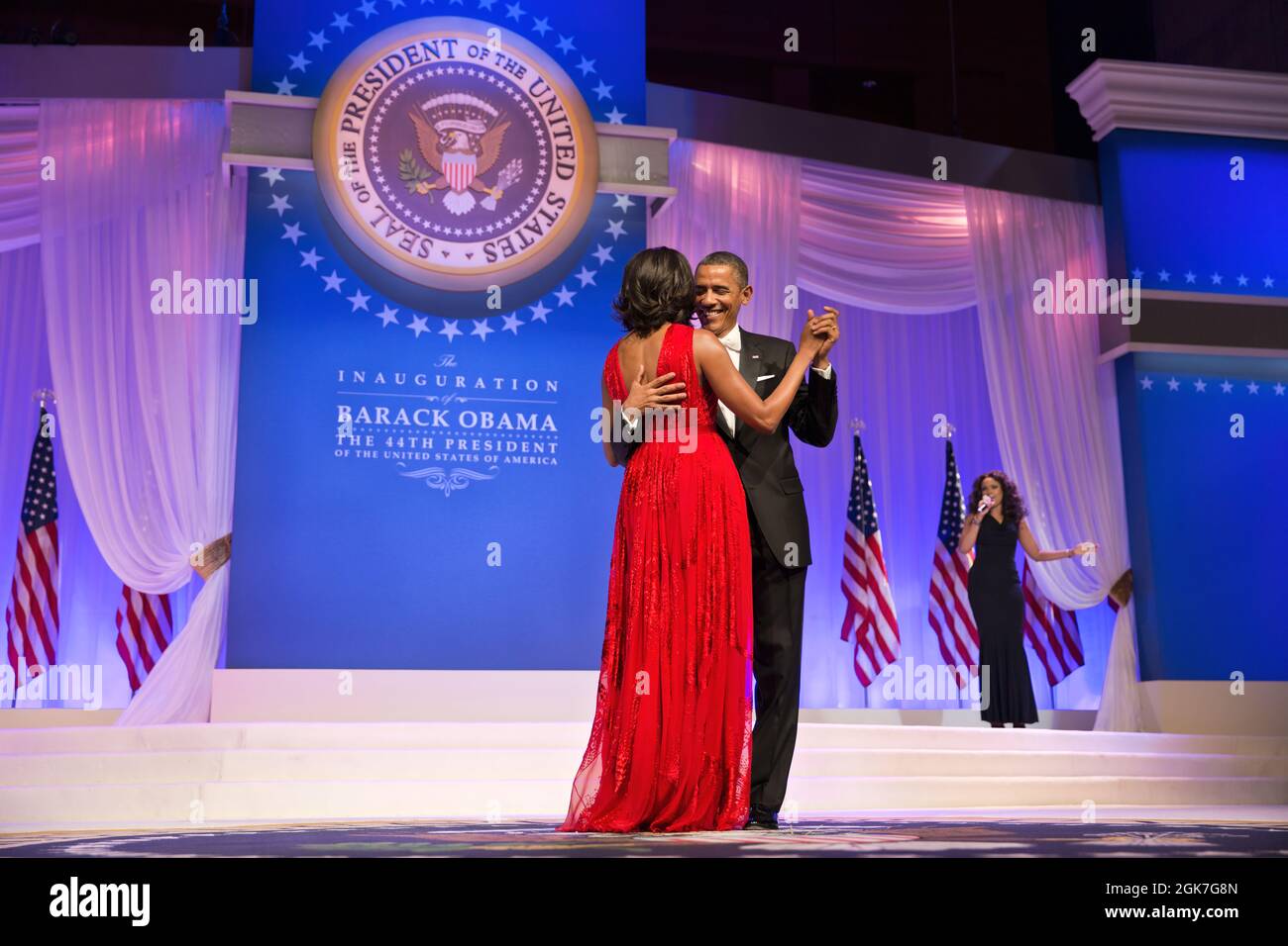 President Barack Obama and First Lady Michelle Obama dance at the Commander in Chief Ball at the Walter E. Washington Convention Center in Washington, D.C., Jan. 21, 2013. The President and First Lady danced to  'Let's Stay Together' performed by Jennifer Hudson, right. (Official White House Photo by Pete Souza) This official White House photograph is being made available only for publication by news organizations and/or for personal use printing by the subject(s) of the photograph. The photograph may not be manipulated in any way and may not be used in commercial or political materials, adver Stock Photo