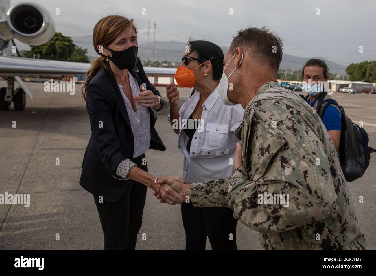 Samantha Power, Administrator for the U.S. Agency for International Development, meets Joint Task Force-Haiti Commander Rear Adm. Keith Davids at the Port-au-Prince international airport on Aug. 26, 2021. Joint Task Force-Haiti deployed quickly to support U.S. Agency for International Development and enable airlift capability to deliver humanitarian aid to remote locations in the southern peninsula of Haiti. Stock Photo