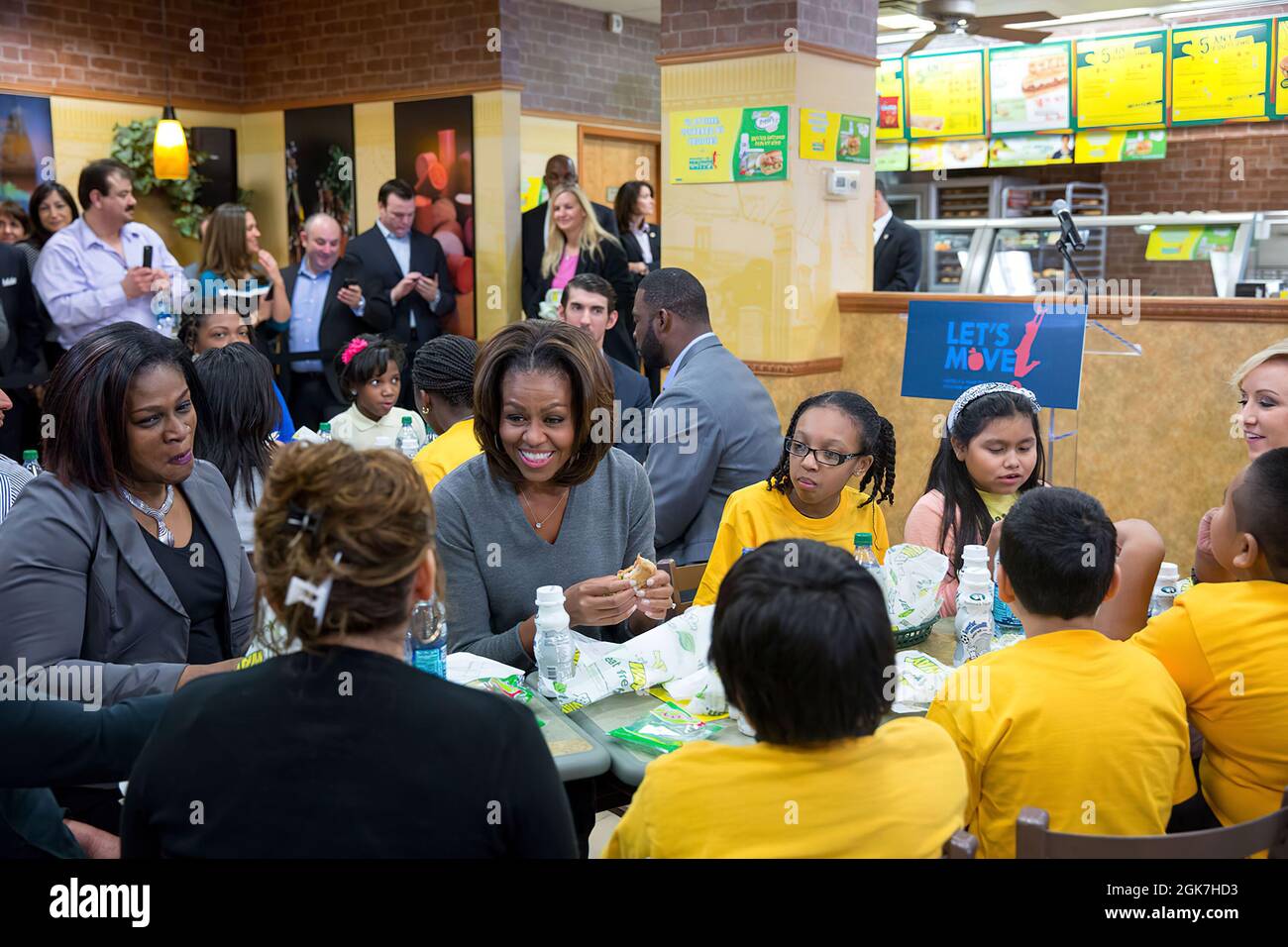 First Lady Michelle Obama joins students and parents  for lunch at a Subway restaurant to announce that Subway will work with Partnership for a Healthier America to help advance the goals of 'Let's Move!,' in Washington, D.C., Jan. 23, 2014. (Official White House Photo by Amanda Lucidon) This official White House photograph is being made available only for publication by news organizations and/or for personal use printing by the subject(s) of the photograph. The photograph may not be manipulated in any way and may not be used in commercial or political materials, advertisements, emails, produc Stock Photo