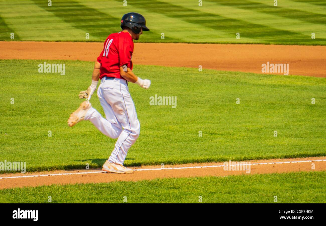 baseball player running the bases after a hit Stock Photo