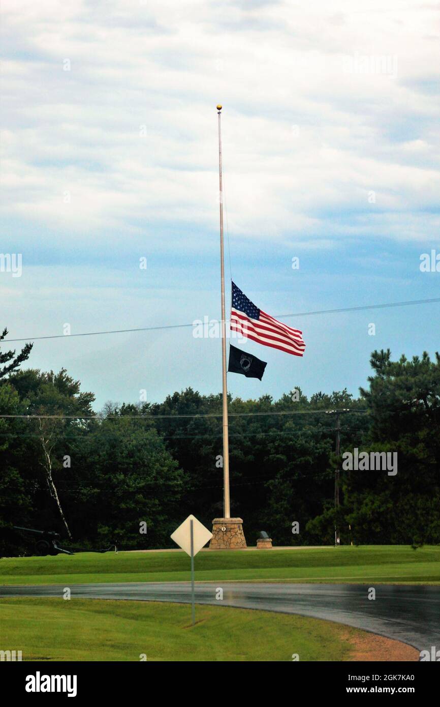 The United States flag flies at half-staff Aug. 27, 2021, at Fort McCoy, Wis. The lowering of the flag was a mark of respect in recognition of the U.S. service members and other victims killed in a terrorist attack Aug. 26, 2021, in Kabul, Afghanistan. According to the Department of Veterans Affairs, an easy way to remember when to fly the United States flag at half-staff is to consider when the whole nation is in mourning. These periods of mourning are proclaimed either by the president of the United States, for national remembrance, or the governor of a state or territory, for local remembra Stock Photo