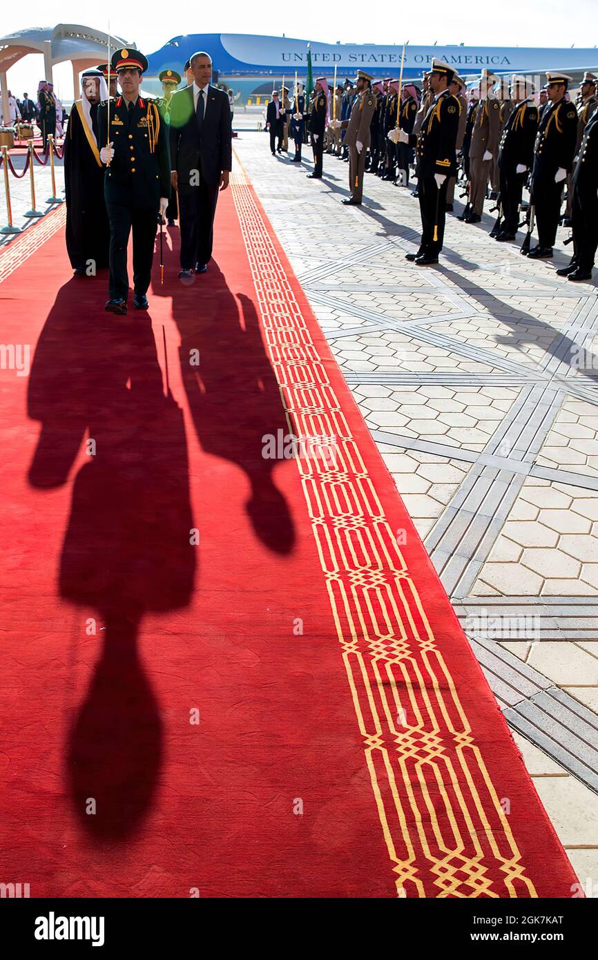 President Barack Obama and King Salman bin Abdulaziz  of Saudi Arabia walk along the red carpet at King Khalid International Airport in Riyadh, Saudi Arabia, Jan. 27, 2015. (Official White House Photo by Pete Souza) This official White House photograph is being made available only for publication by news organizations and/or for personal use printing by the subject(s) of the photograph. The photograph may not be manipulated in any way and may not be used in commercial or political materials, advertisements, emails, products, promotions that in any way suggests approval or endorsement of the Pr Stock Photo