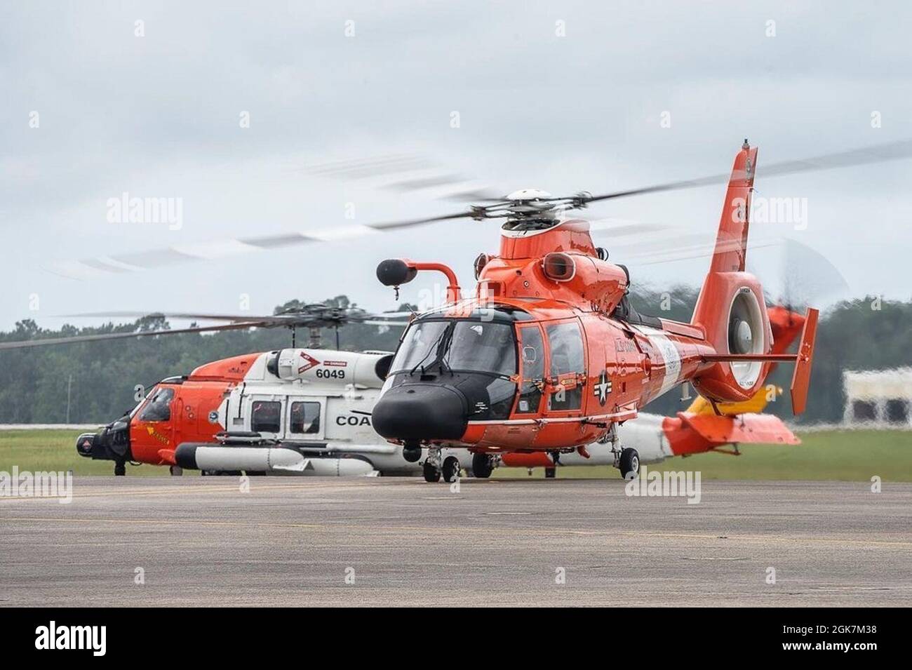 An MH-65 Dolphin helicopter crew conduct a training flight at Aviation Training Center Mobile in Alabama on Aug. 27, 2021, ahead of Hurricane Ida. Coast Guard crew prepare and relocate aircraft out of the main path of the storm to be ready to respond as soon as the worst passes. Stock Photo