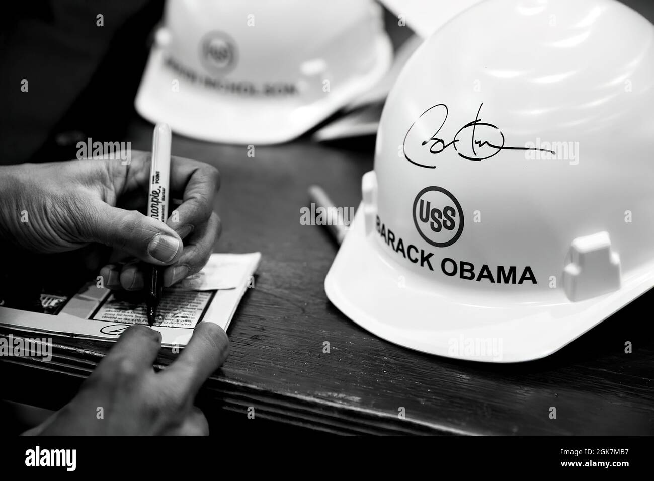 President Barack Obama signs hard hats and other items after delivering remarks at the United States Steel Corporation Irvin Plant in West Mifflin, Penn., Jan. 29, 2014. (Official White House Photo by Pete Souza) This official White House photograph is being made available only for publication by news organizations and/or for personal use printing by the subject(s) of the photograph. The photograph may not be manipulated in any way and may not be used in commercial or political materials, advertisements, emails, products, promotions that in any way suggests approval or endorsement of the Presi Stock Photo