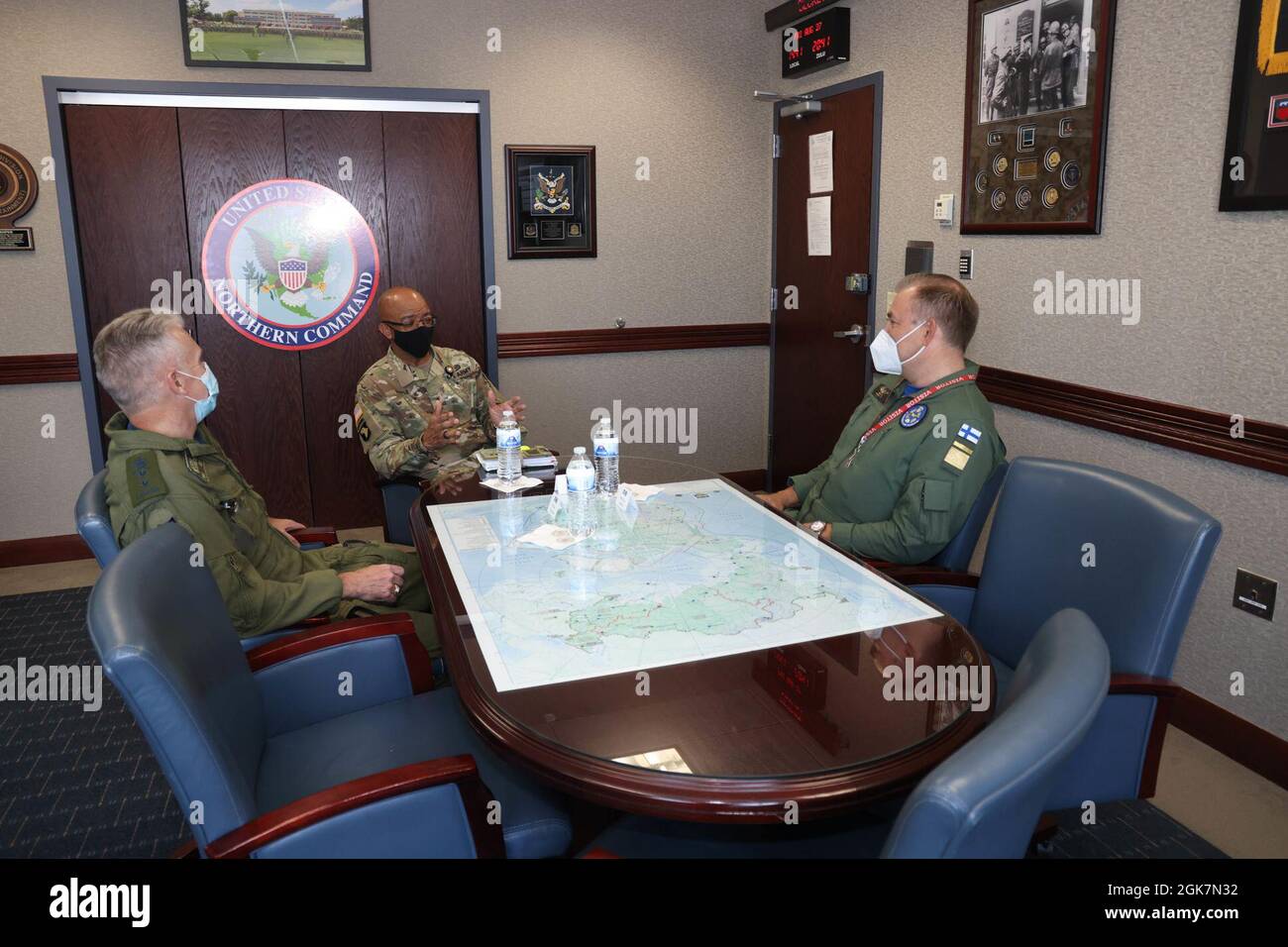 Canadian MGen. Patrick Carpentier, Director, North American Aerospace Defense Command Operations (Left), and U.S. Army Lt. Gen. A.C. Roper, Deputy Commander, U.S. Northern Command (Center), speak with Maj. Gen. Pasi Jokinen, Finnish Air Force Commander (Right), in the NORAD and USNORTHCOM headquarters in Colorado Springs, Colorado, Aug 27, 2021.  The leaders discussed NORAD’s mission, objectives and capabilities, as well as the United States perspective on Arctic strategy. (Department of Defense photo by Mr. Jhomil Bansil) Stock Photo