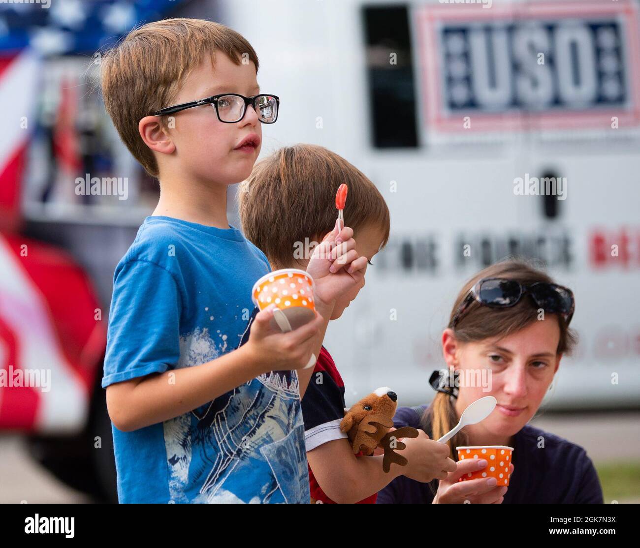 Tanya Collie, along with her sons Nathaniel , 9, and Noah, 6, have ice cream at the Women’s Equality Day event Aug. 27, 2021, on Wright-Patterson Air Force Base, Ohio. The event, marking the anniversary of the 19th Amendment’s ratification granting women the right to vote, featured live music, food, base organization booths and local women-owned craft vendors. Stock Photo