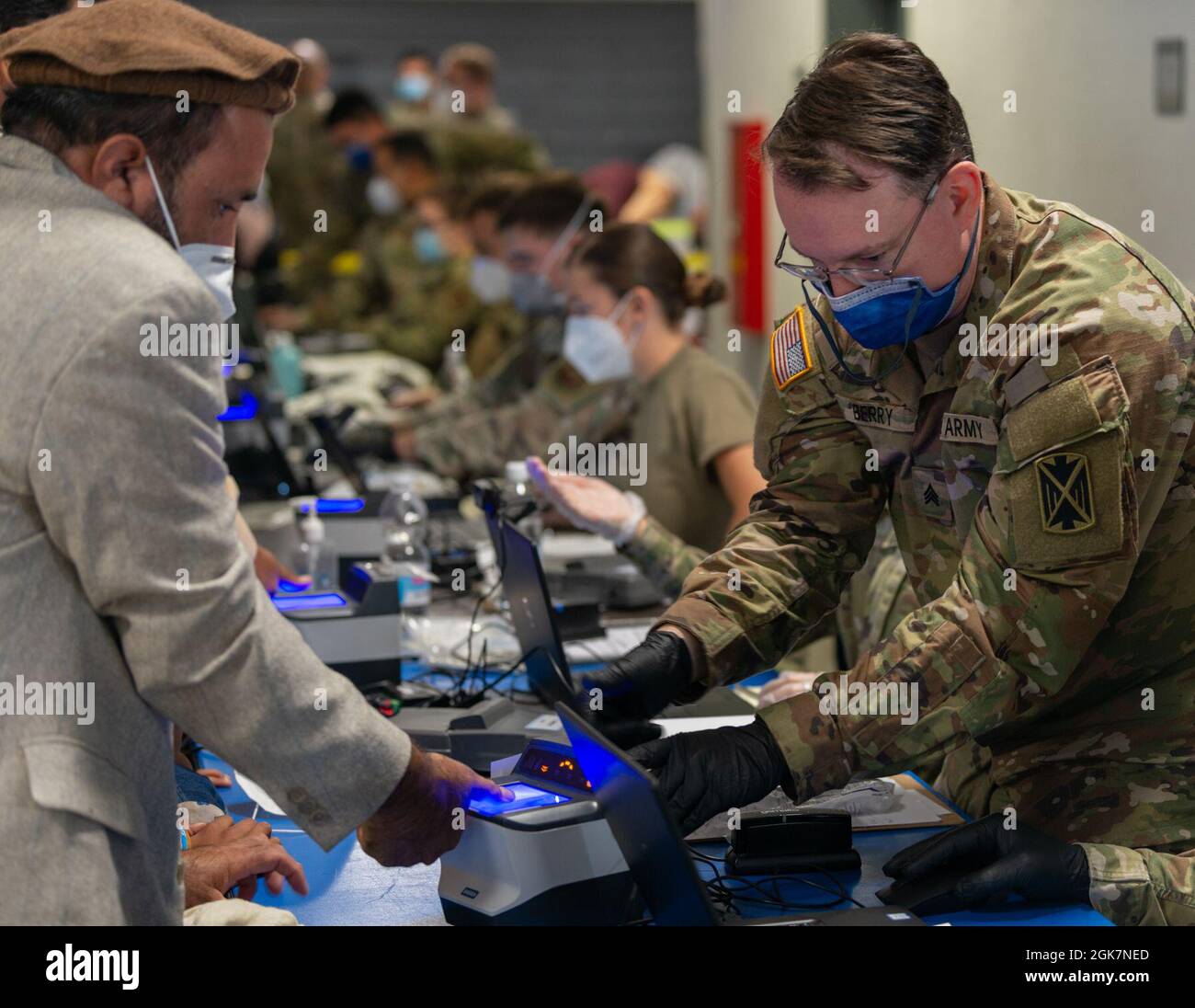 A U.S. Army Soldier processes evacuees at Ramstein Air Base, Germany ...