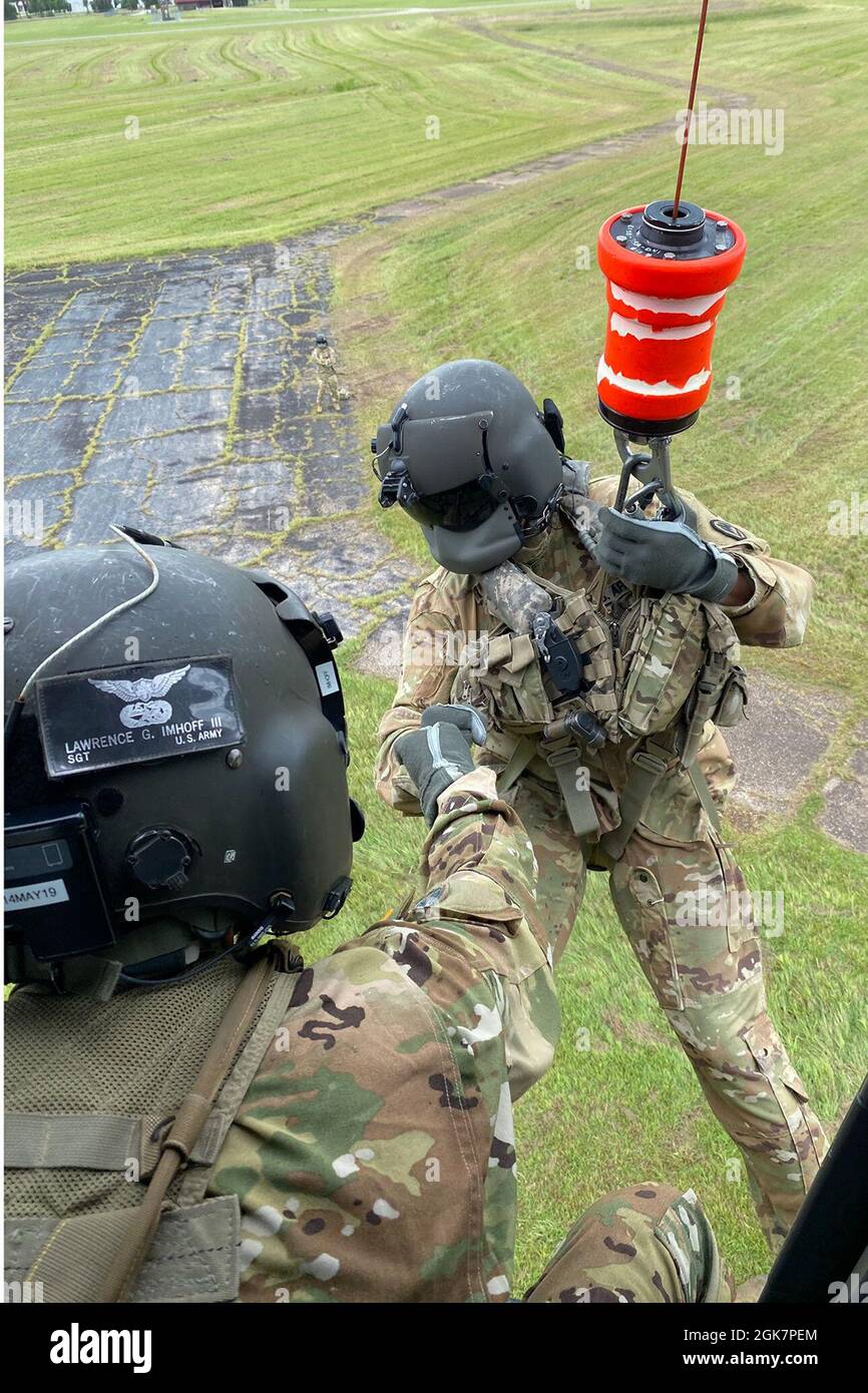 Soldiers with the Louisiana National Guard’s 1st Battalion, 244th Aviation Regiment, rehearse hoist operations to prepare for possible search and rescue missions ahead of Hurricane Ida in Hammond, Louisiana, Aug. 28, 2021. In addition to 195 high-water vehicles and 73 rescue boats prepped and staged across south Louisiana, the LANG has 34 helicopters ready to support search and rescue, evacuation and recon missions as needed. Stock Photo