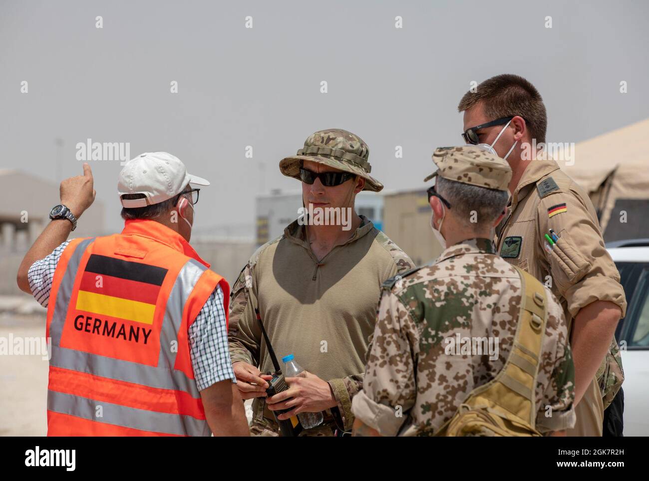 U.S. and German Armed Forces service members coordinate to locate personnel at Al Udeid Air Base, Qatar, Aug. 28, 2021. The U.S. military and coalition forces remains committed with supporting with the evacuation of Special Immigrant Visa applicants and other at-risk individuals from Afghanistan as quickly and safely as possible. Stock Photo