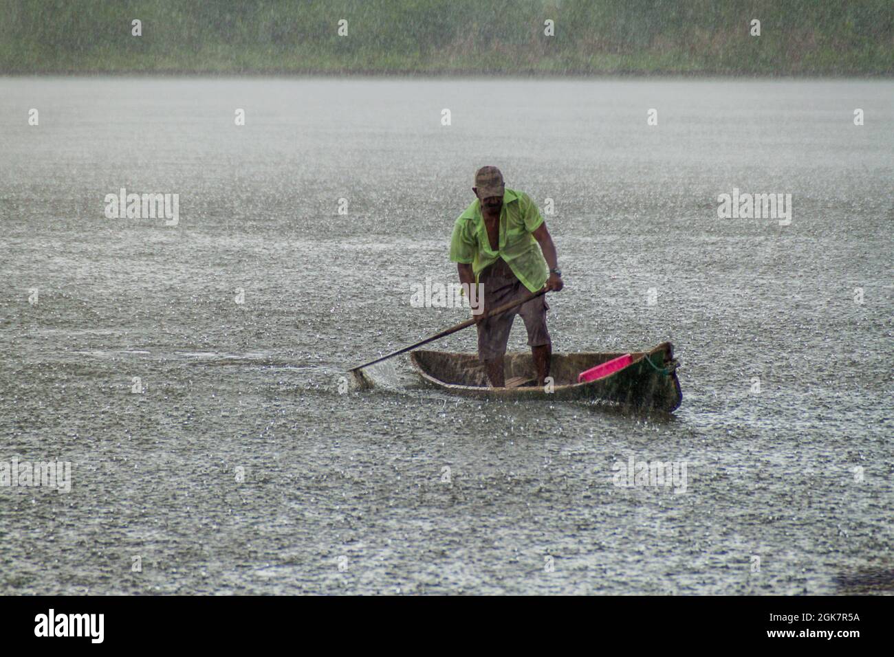 PORTOBELO, PANAMA - MAY 28, 2016: Local man in his canoe during a heavy rain  Stock Photo - Alamy