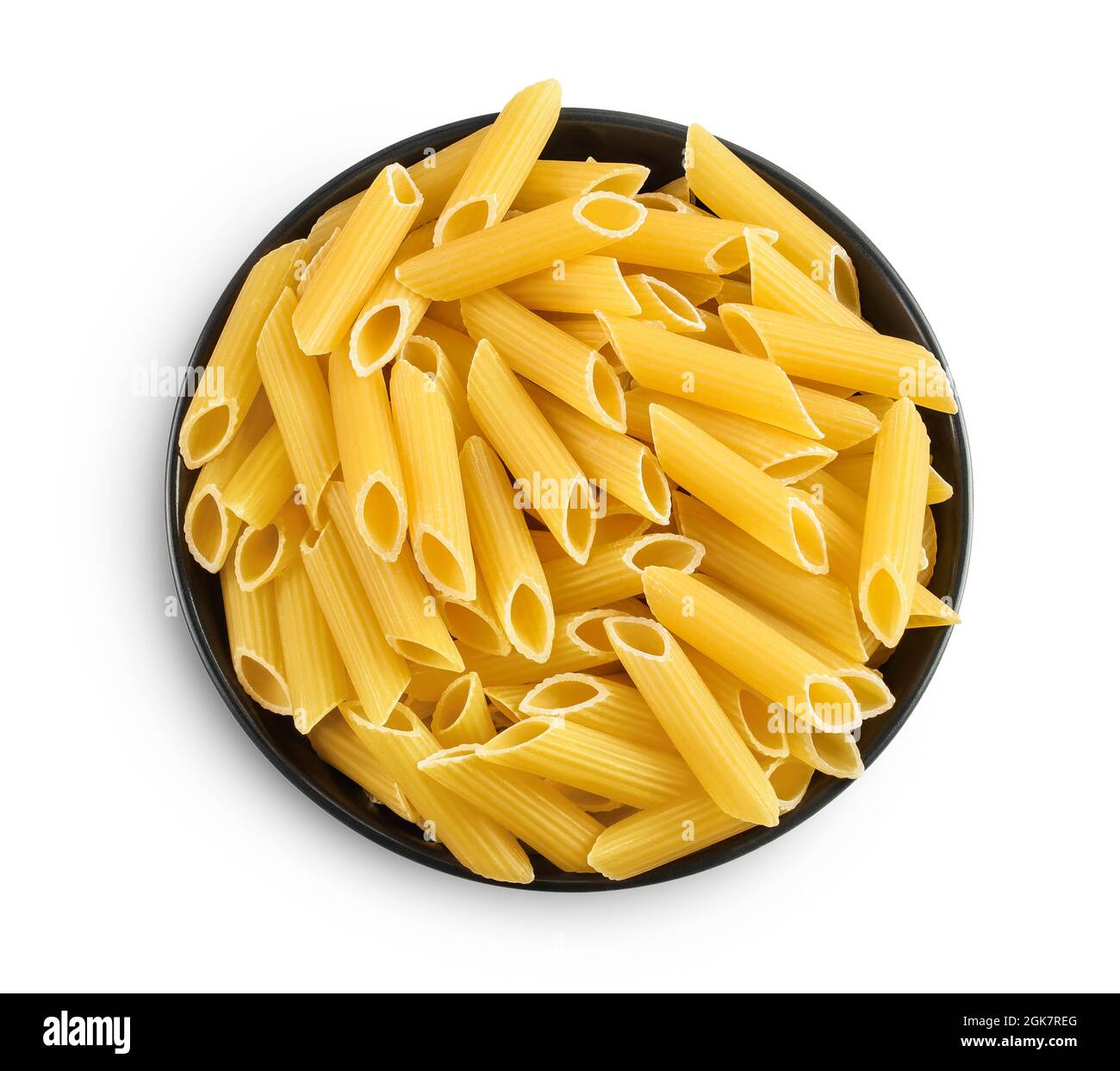 Raw italian penne rigate pasta in black bowl isolated on white background with clipping path and full depth of field. Top view. Flat lay Stock Photo