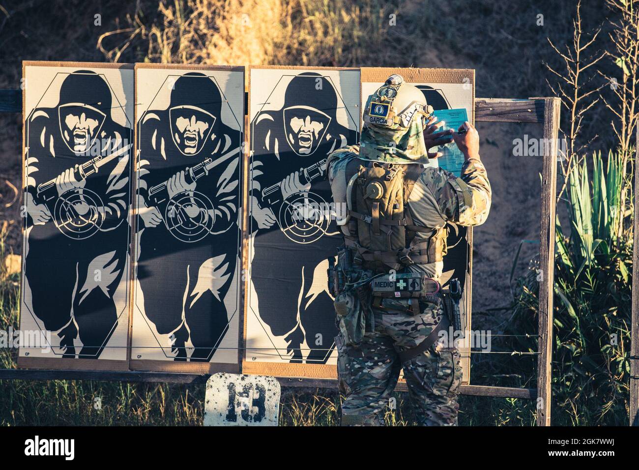 U.S. Army 1st Sgt. Edwin Garcia, Kentucky National Guard, checks his targets after shooting a