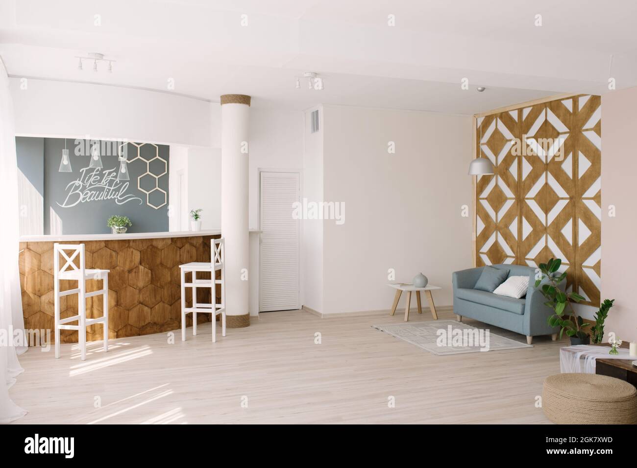 Stylish interior with designer wood wall and blue sofa sofa, coffee ...