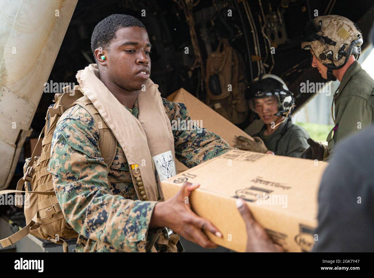 U.S. Marine Corps Lance Cpl. Lunel Najac delivers cases of food in support of Joint Task Force-Haiti for a humanitarian assistance and disaster relief mission in Jeremie, Haiti, Aug. 31, 2021. Najac, a maintenance administrator with Marine Heavy Helicopter Squadron 461, is attached as an interpreter for Marine Medium Tiltrotor Squadron 266, 2nd Marine Aircraft Wing, II Marine Expeditionary Force. Stock Photo