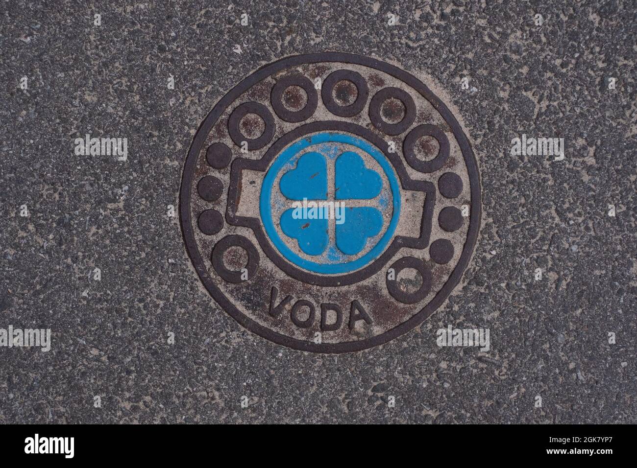 Manhole cover-up on a public asphalt city road in Pärnu, Estonia. Attention to detail. Stock Photo