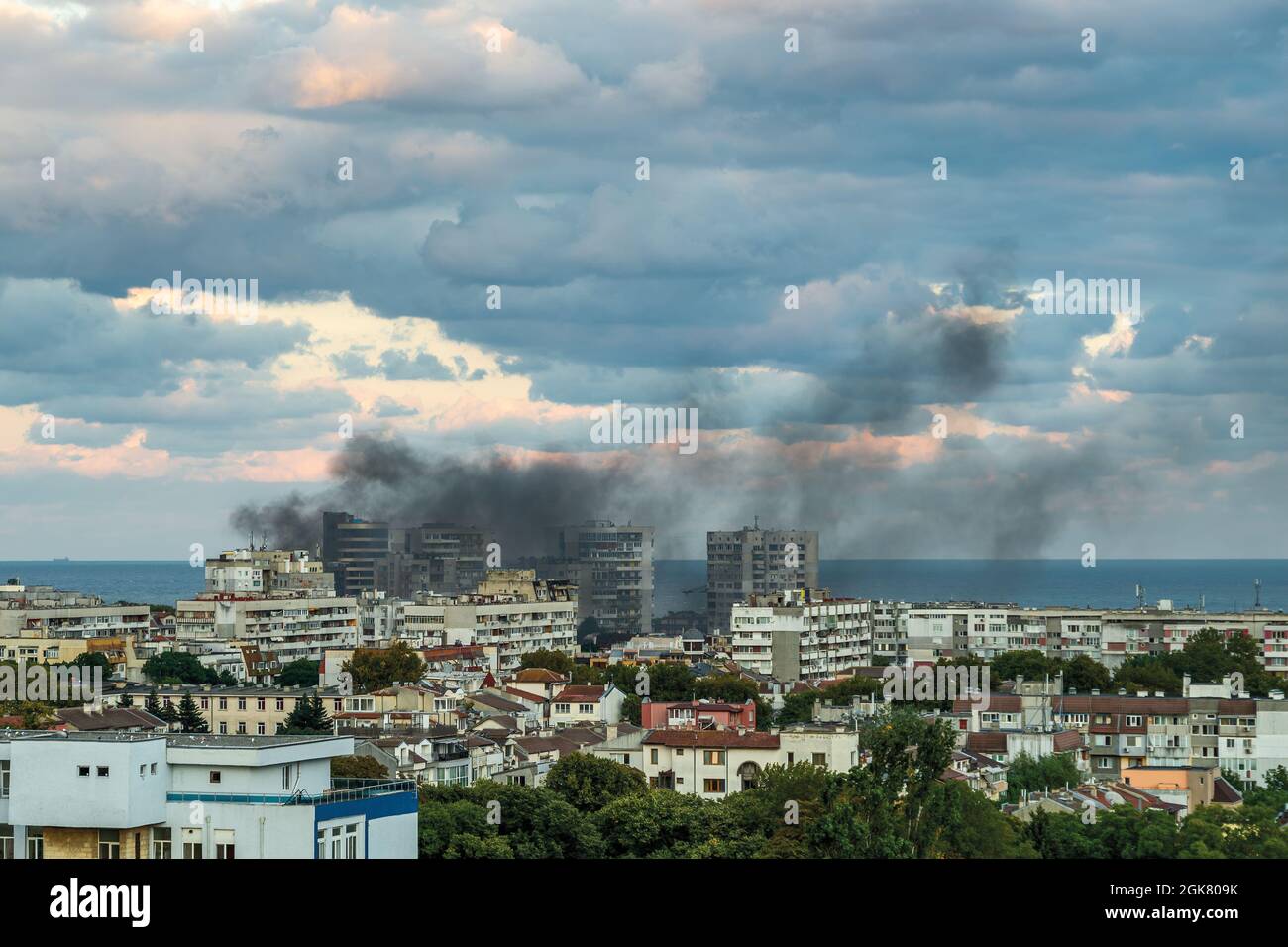 Fire accident in a small seaside town on a summer day. A multi-storey  residential building is on fire. Puffs of thick black smoke drift through  the ai Stock Photo - Alamy