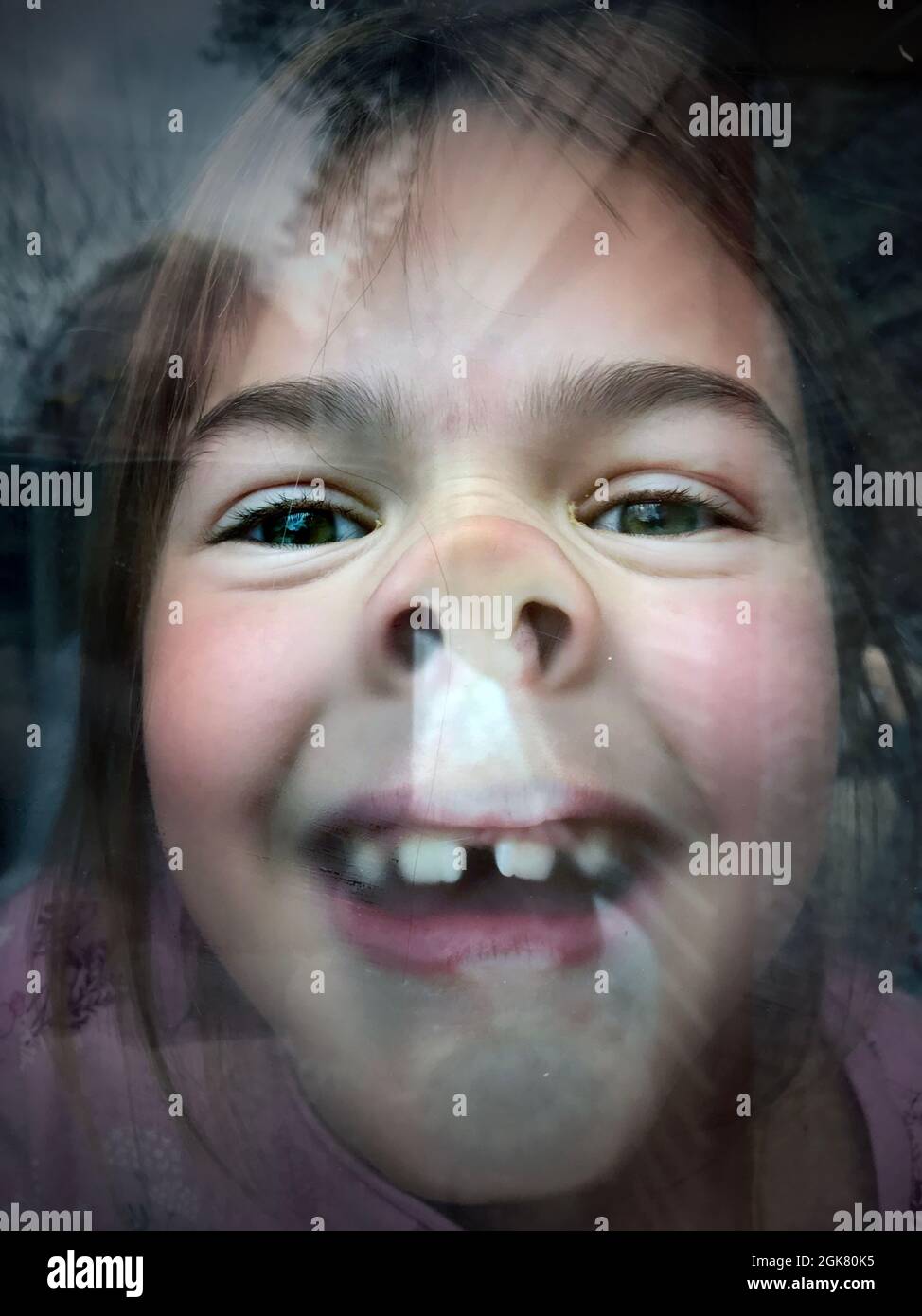 childs face pressed against window pane looking out Stock Photo Alamy