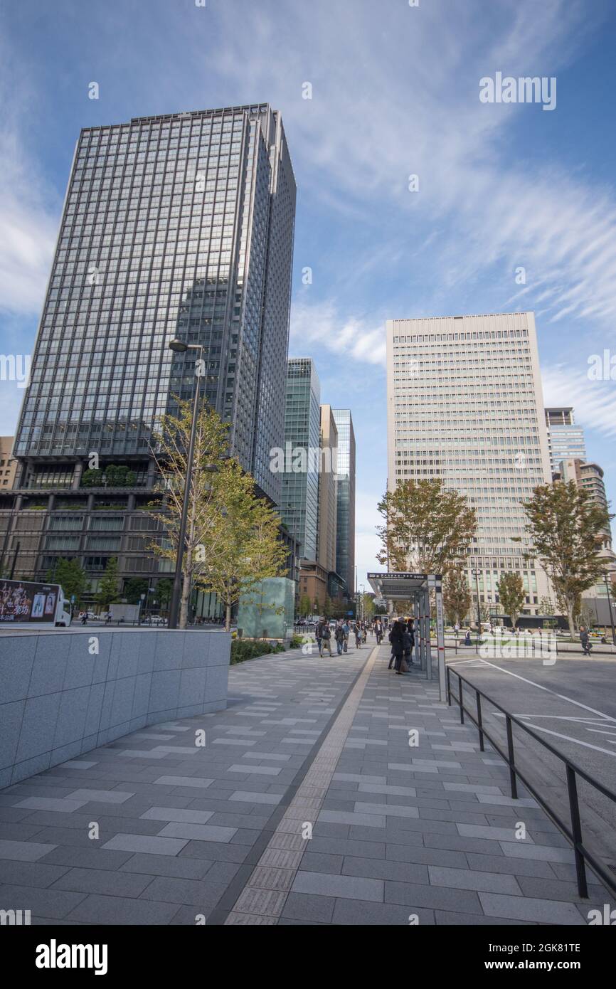 People walking among skyscrapers in Tokyo's CBD, located near to Tokyo Central train station, Japan, October Stock Photo