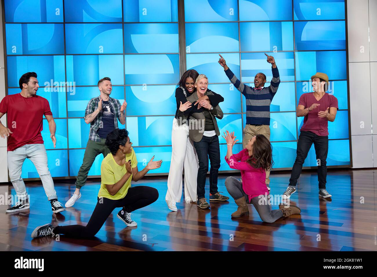 First Lady Michelle Obama hugs Ellen DeGeneres after they perform a #GimmeFive 'Let's Move!' dance with the 'So You Think You Can Dance' dancers during a taping of The Ellen DeGeneres Show in Burbank, Calif., March 12, 2015. (Official White House Photo by Amanda Lucidon) This official White House photograph is being made available only for publication by news organizations and/or for personal use printing by the subject(s) of the photograph. The photograph may not be manipulated in any way and may not be used in commercial or political materials, advertisements, emails, products, promotions th Stock Photo