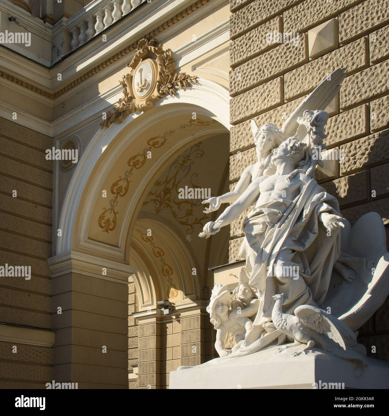 Antique statue and classical building with arc Stock Photo
