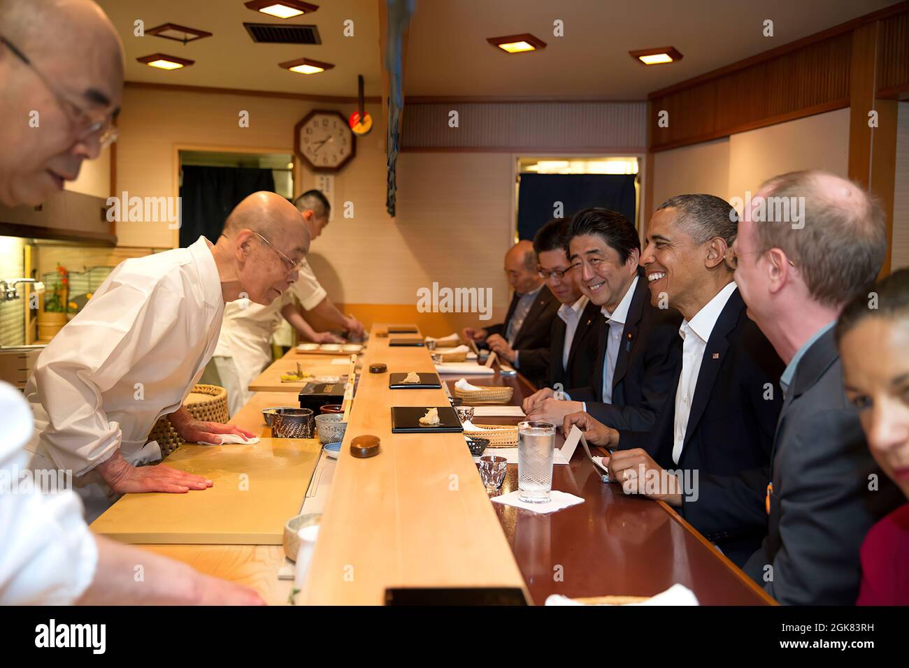 President Barack Obama and Prime Minister Shinzo Abe of Japan talk with sushi master Jiro Ono, owner of Sukiyabashi Jiro sushi restaurant, during a dinner in Tokyo, Japan, April 23, 2014. (Official White House Photo by Pete Souza)  This official White House photograph is being made available only for publication by news organizations and/or for personal use printing by the subject(s) of the photograph. The photograph may not be manipulated in any way and may not be used in commercial or political materials, advertisements, emails, products, promotions that in any way suggests approval or endor Stock Photo