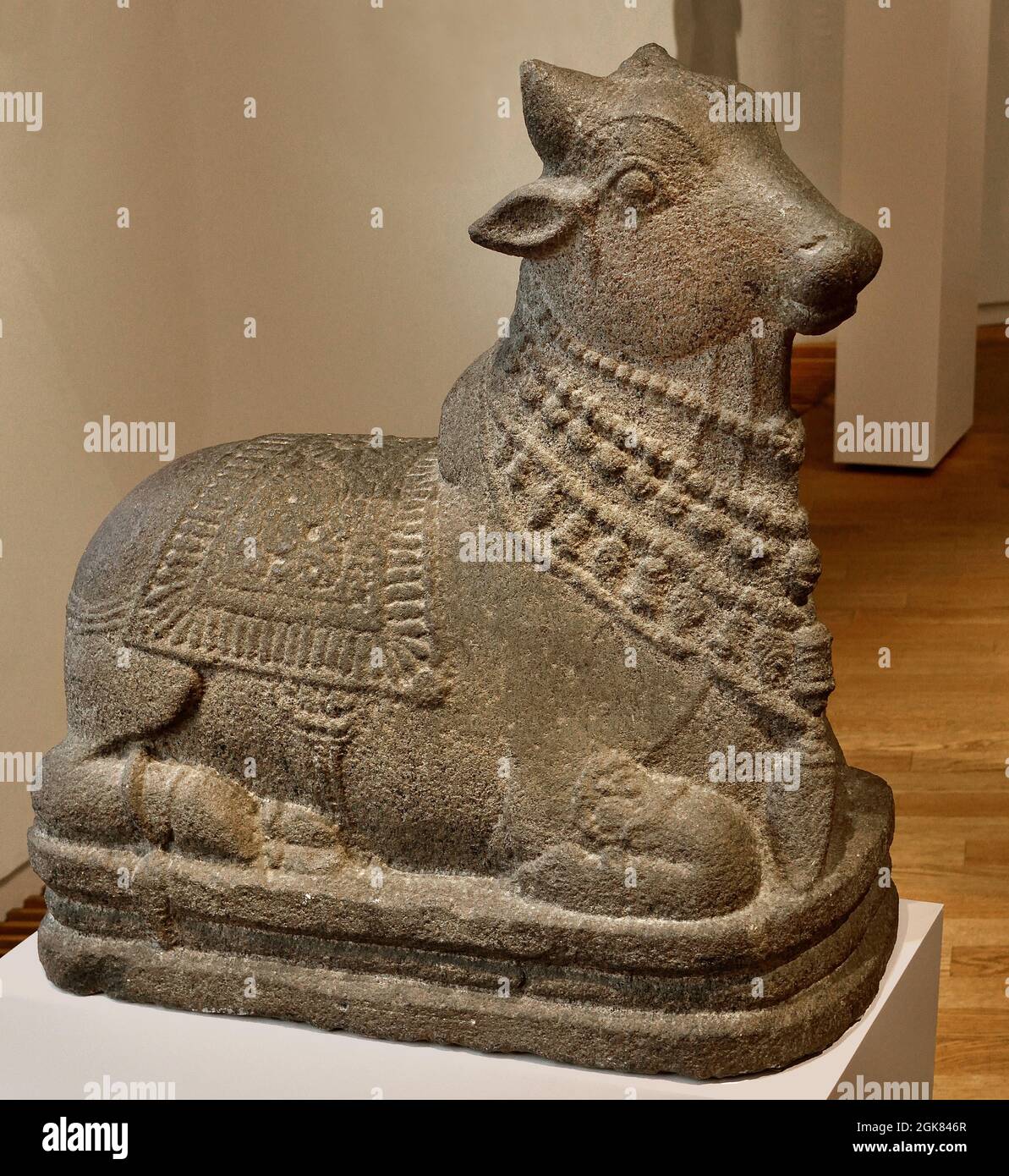 Reclining bull, ( Shiva's mount is the bull: the symbol of strength and fertility. The bull is harnessed as a god's mount. ) 1000 - 1200 , style Chola, sandstone, 63.0cm × 64.0cm × 29.0cm, India ,Tamil, Nadu. Stock Photo