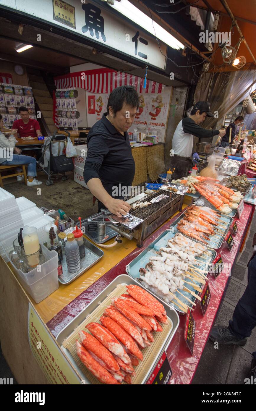 Fish stalls with freshly caught produce at Kuromon Ichiba Market, Osaka, Japan Stock Photo