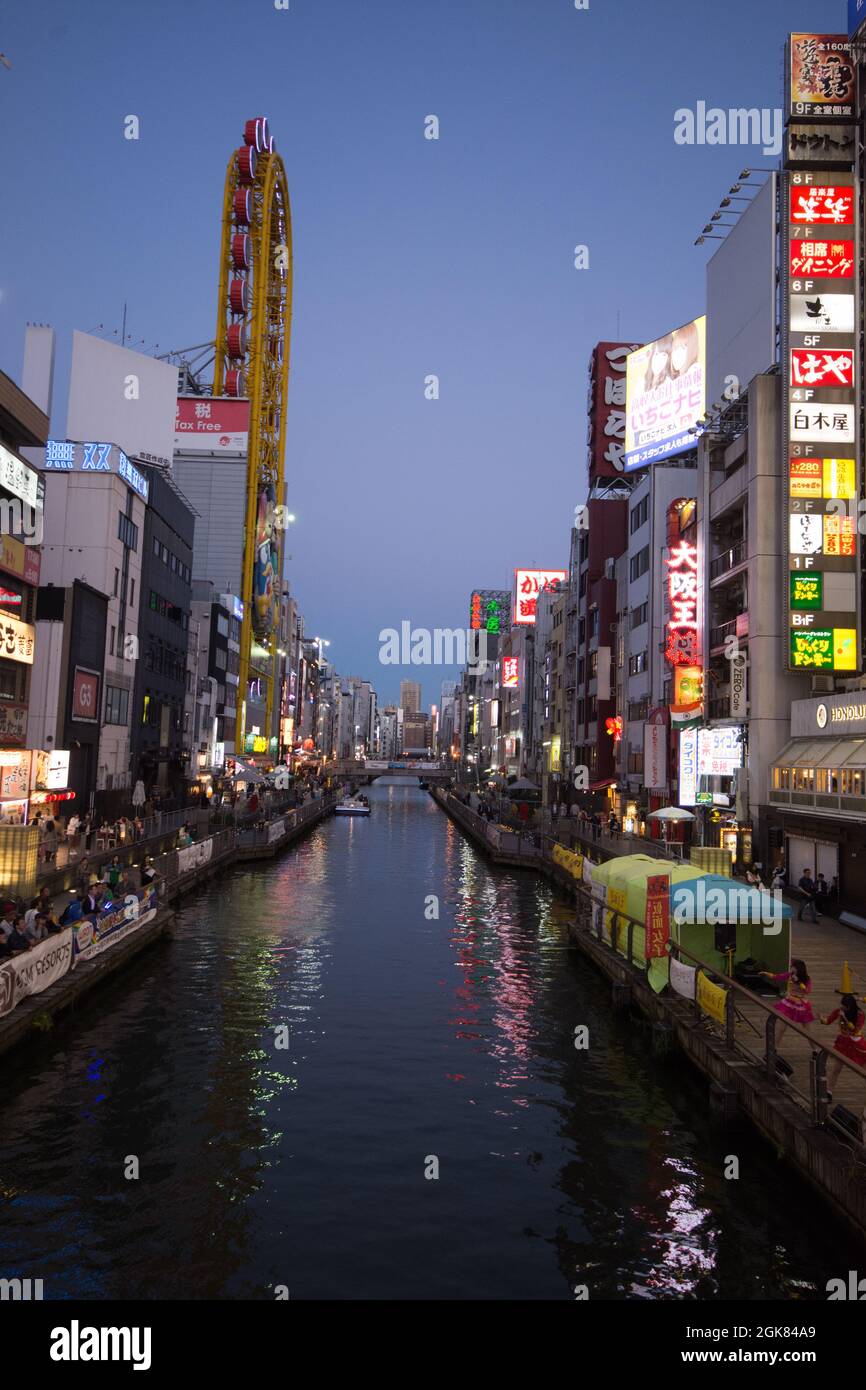Osaka reflected in the Dotonbori river at twilight, Japan Stock Photo