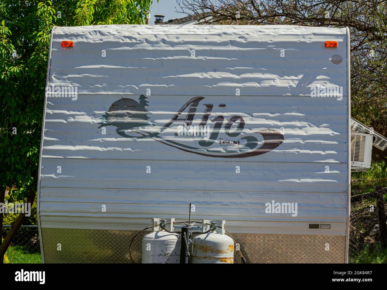 Hail damage from thunderstorm shows as dents to the aluminum exterior coating to older vacation trailer, Castle Rock Colorado USA. Photo taken in May. Stock Photo