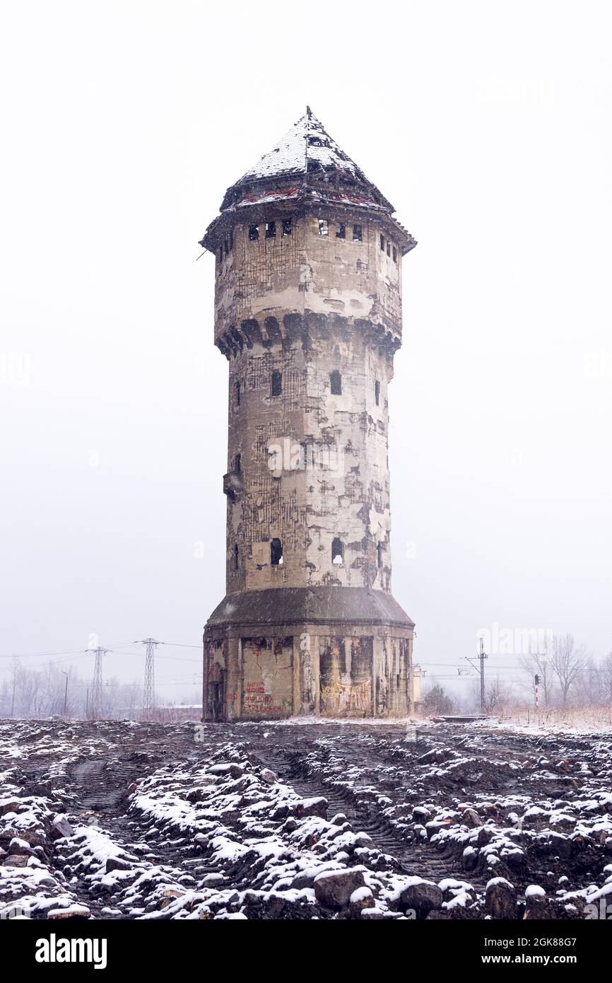 Winter view on an abandoned water tower in former Uthemann ironwork. in Katowice, Silesia, Poland. Stock Photo