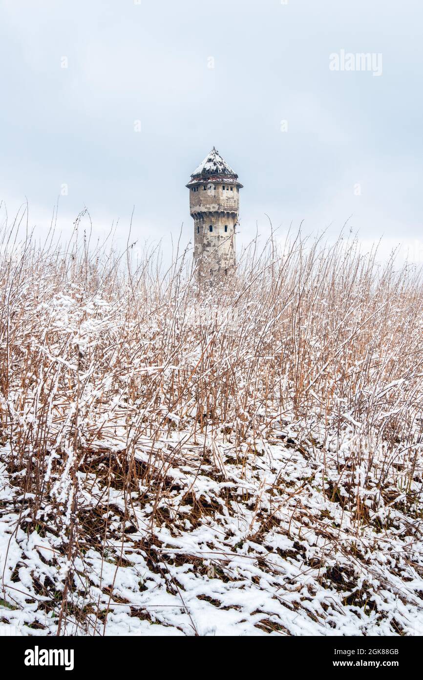 Winter view on an abandoned water tower in former Uthemann ironwork. in Katowice, Silesia, Poland. Stock Photo