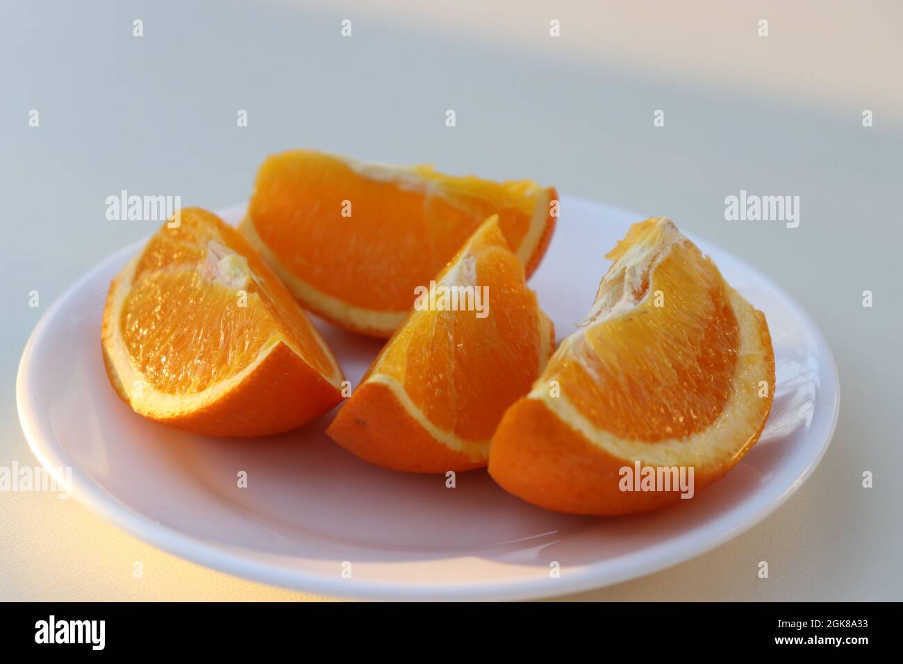 Halthy beautiful colored orange slices on a white background lat. Citrus aurantium Stock Photo