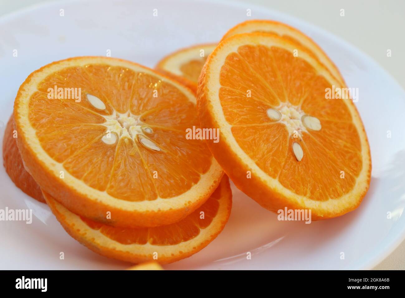 Halthy beautiful colored orange slices on a white background lat. Citrus aurantium Stock Photo