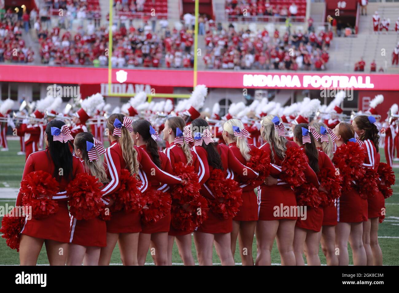BLOOMINGTON, UNITED STATES - 2021/09/11: Indiana University cheerleaders wear American flag ribbons in their hair on the anniversary of 9/11 before IU plays against Idaho during an NCAA football game on September 11, 2021 at Memorial Stadium in Bloomington, Ind. The Hoosiers beat the Vandals 56-14. Stock Photo