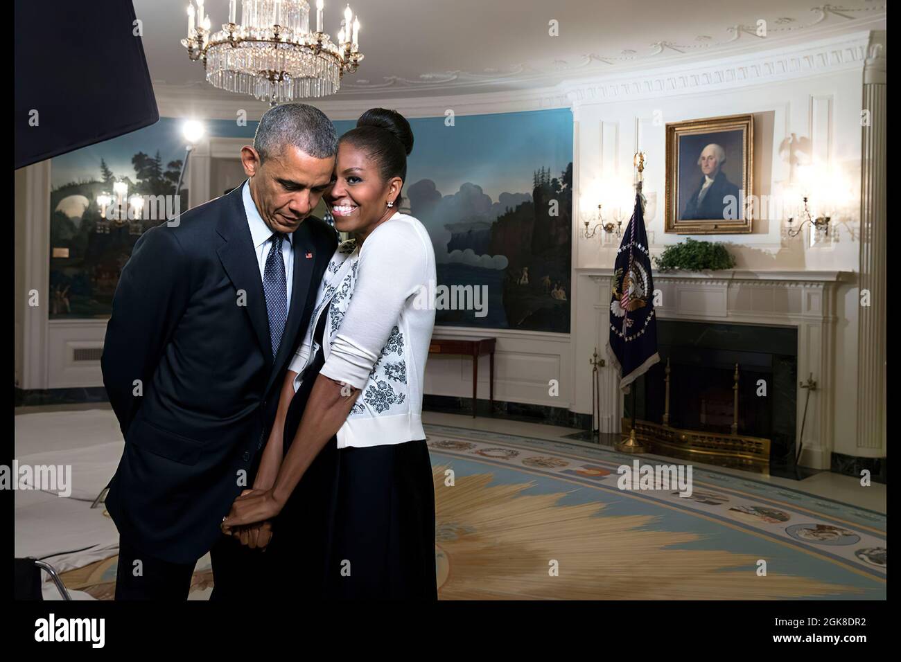 First Lady Michelle Obama snuggles against President Barack Obama before a videotaping for the 2015 World Expo, in the Diplomatic Reception Room of the White House, March 27, 2015. (Official White House Photo by Amanda Lucidon) This official White House photograph is being made available only for publication by news organizations and/or for personal use printing by the subject(s) of the photograph. The photograph may not be manipulated in any way and may not be used in commercial or political materials, advertisements, emails, products, promotions that in any way suggests approval or endorseme Stock Photo