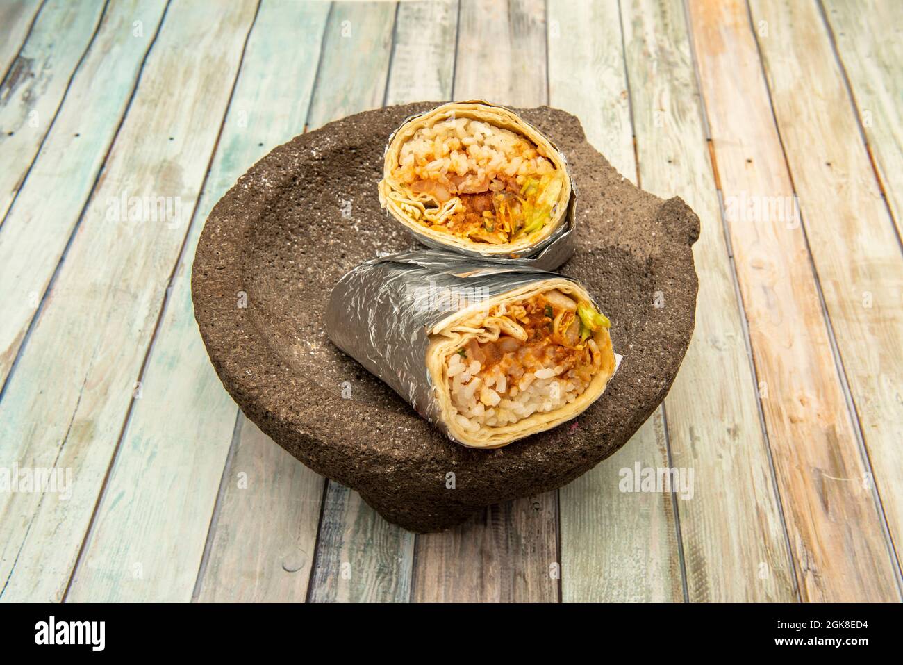 Huge and delicious Mexican chili con carne burrito dipping the rice and