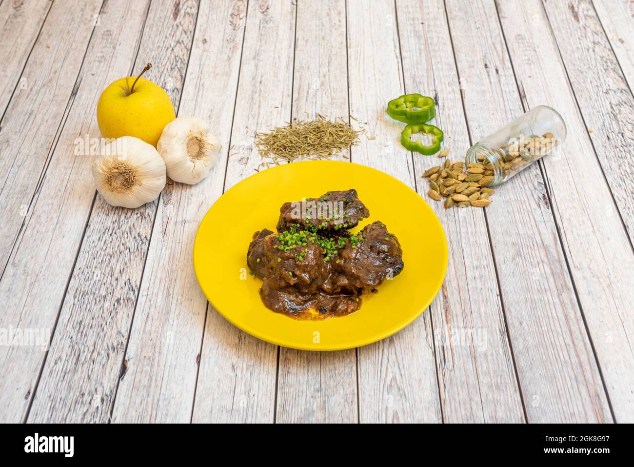 Pork cheeks by raw ingredients of the recipe on white table