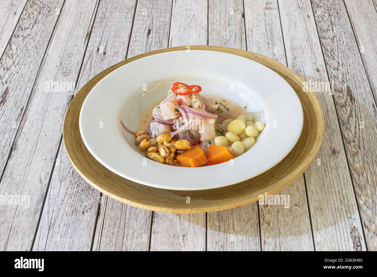 Typical peruvian sea bass ceviche marinated with red onion, peppers