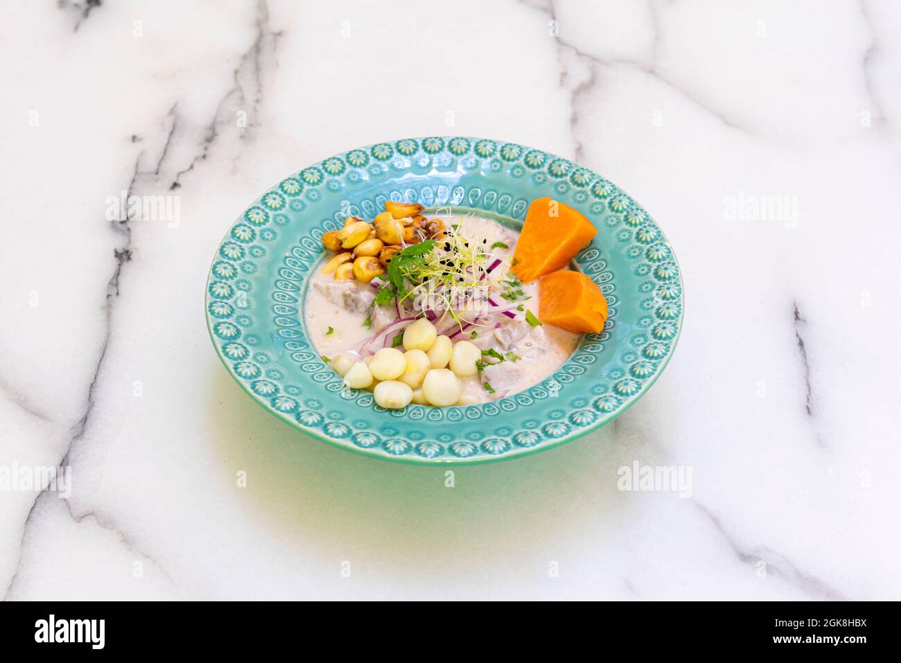 Classic Peruvian ceviche with marinated sea bass, grains of two