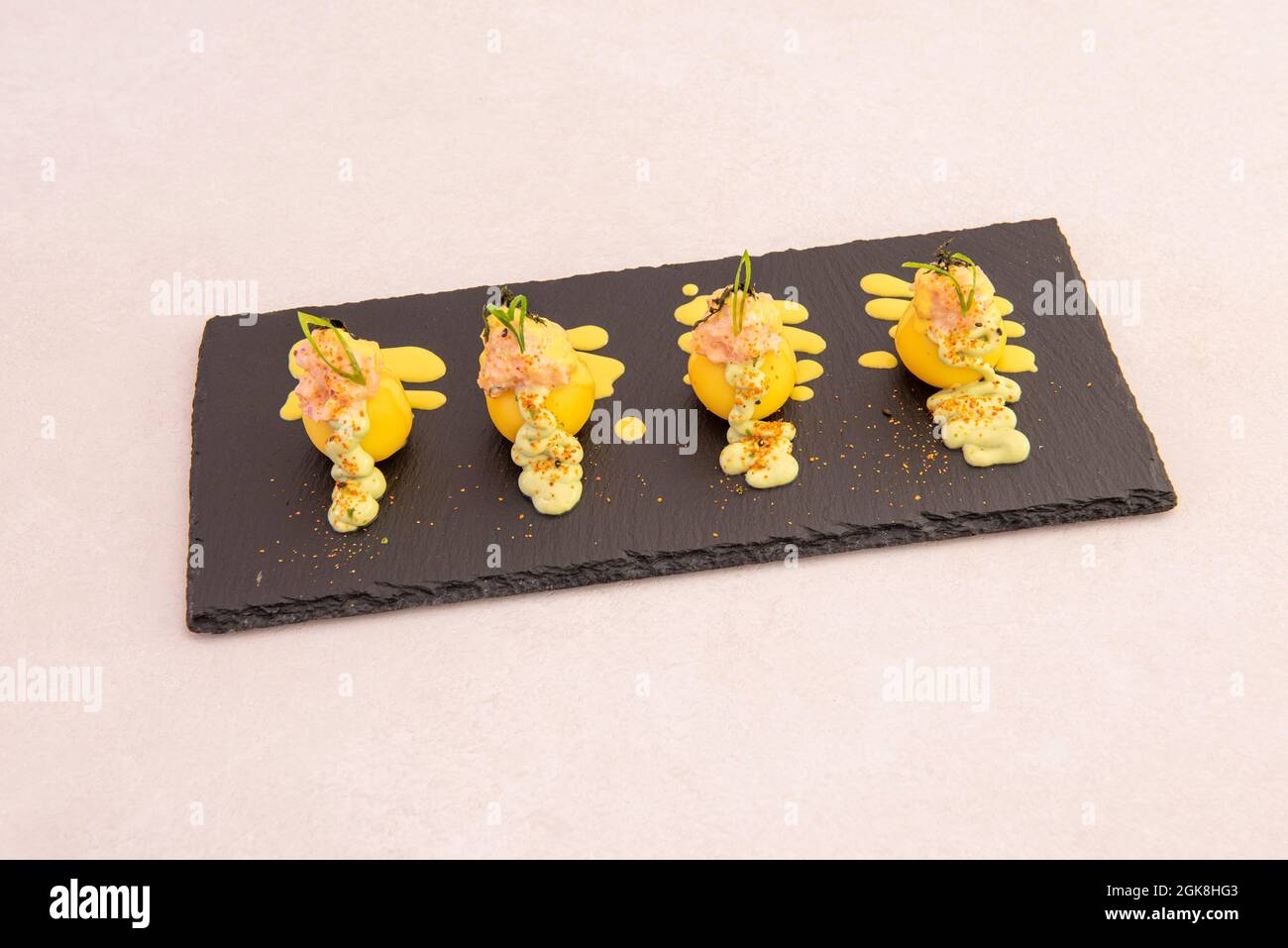 Sophisticated appetizers from Peruvian causa limeña on black slate and