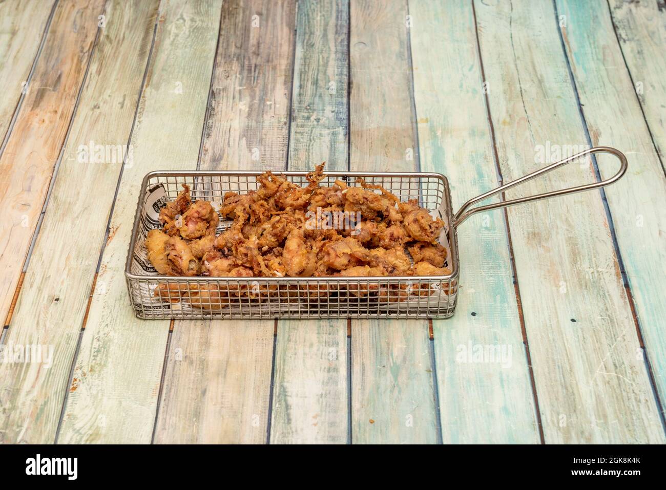 Tray of breaded fried baby squid served in a Spanish tapas restaurant