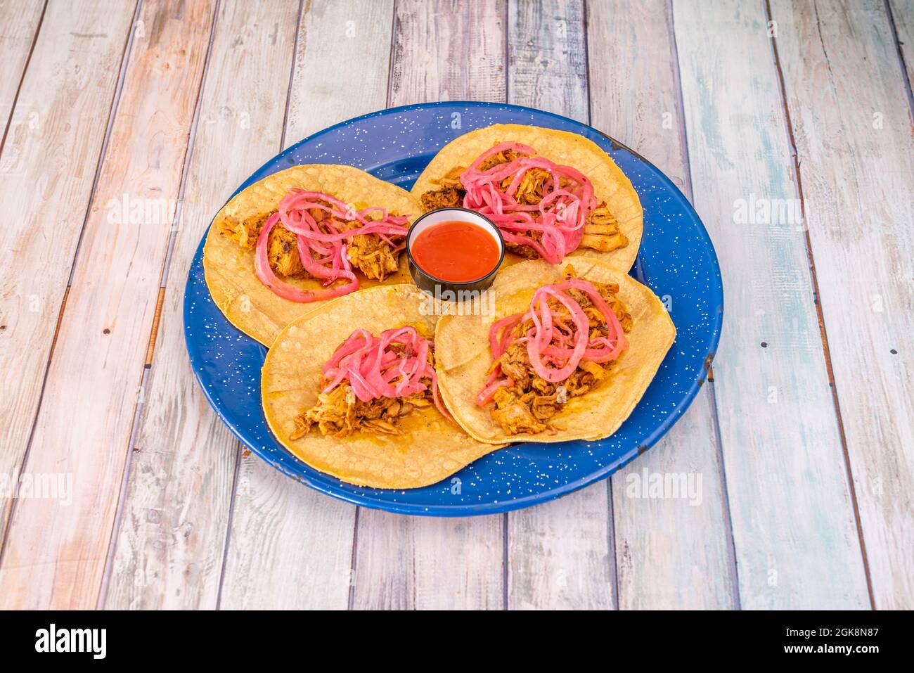 four Mexican corn tortilla tacos with a recipe for a cochinita pibil