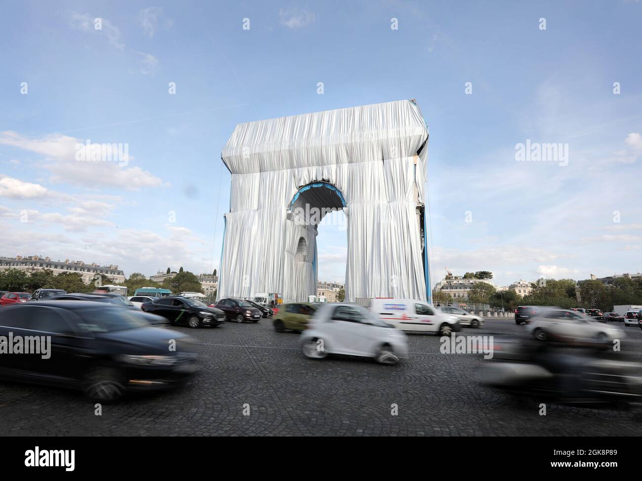 Paris, France. 13th Sep, 2021. Commuters drive around the Arc de Triomphe as it is being wrapped in silvery blue fabric in Paris, France, on Monday, September 30, 2021. The landmark is covered with 25,000 square meters of material, posthumously fulfilling a 60-year dream for the artist Christo. Photo by Eco Clement/UPI Credit: UPI/Alamy Live News Stock Photo