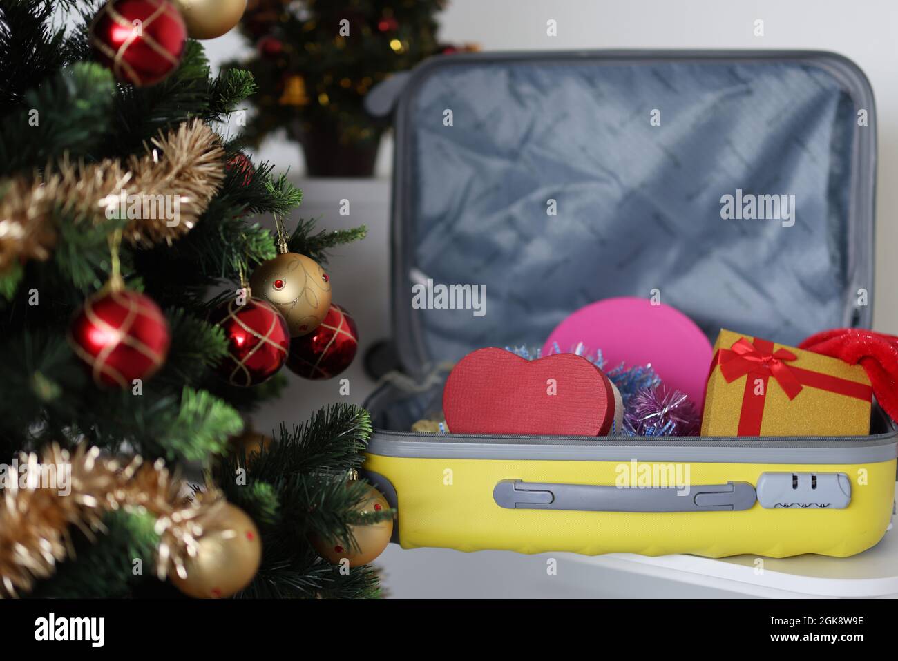 Christmas tree and suitcase with gift boxes closeup Stock Photo Alamy